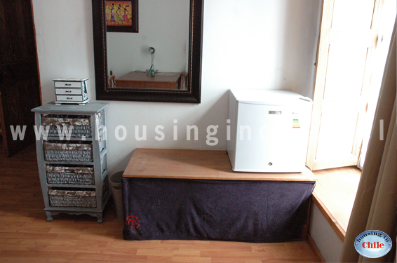 RE-EG: Room 11 with a small fridge and window to the street